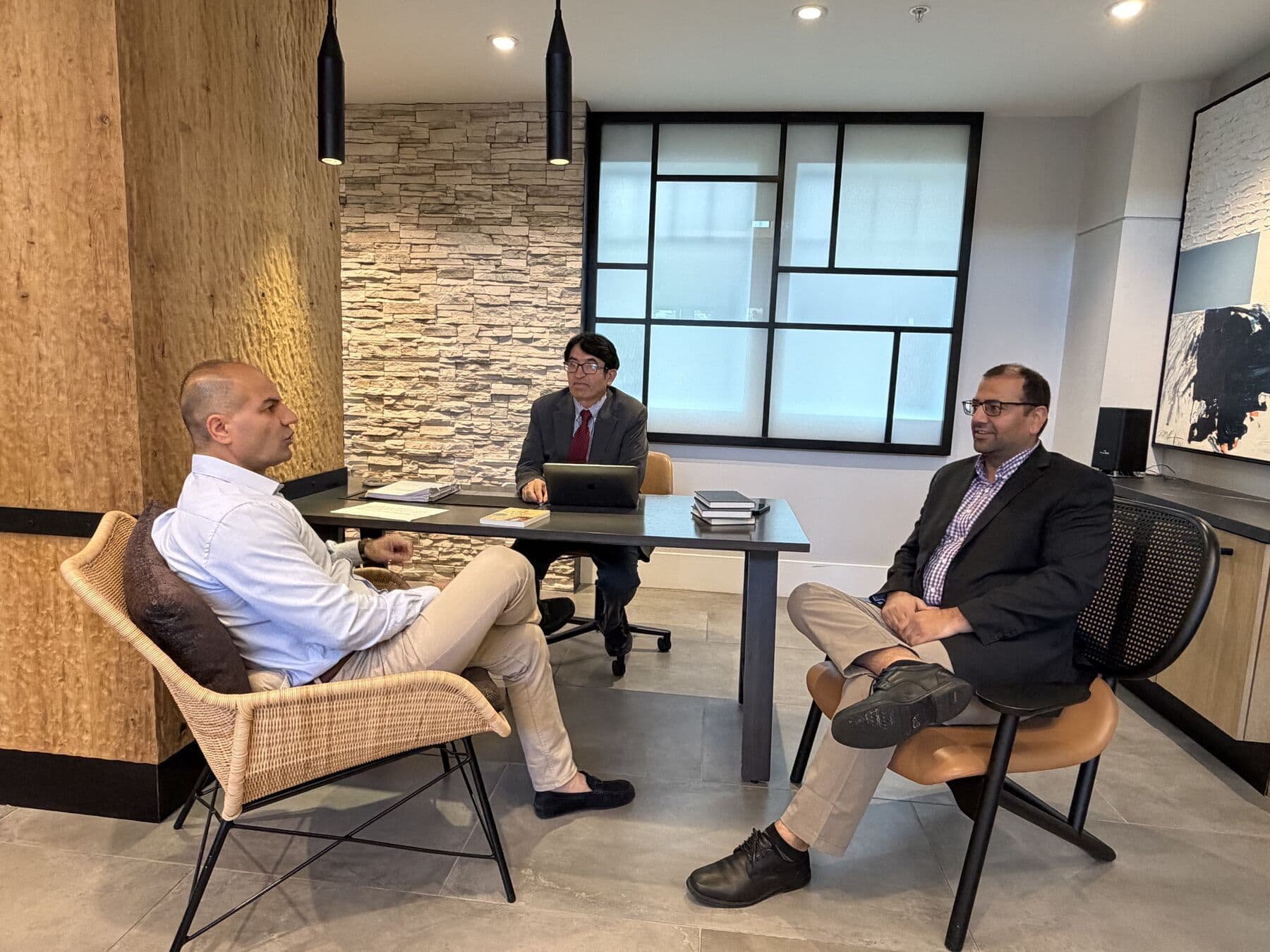 Three members of the Starforce team in conversation in a sunlit meeting space