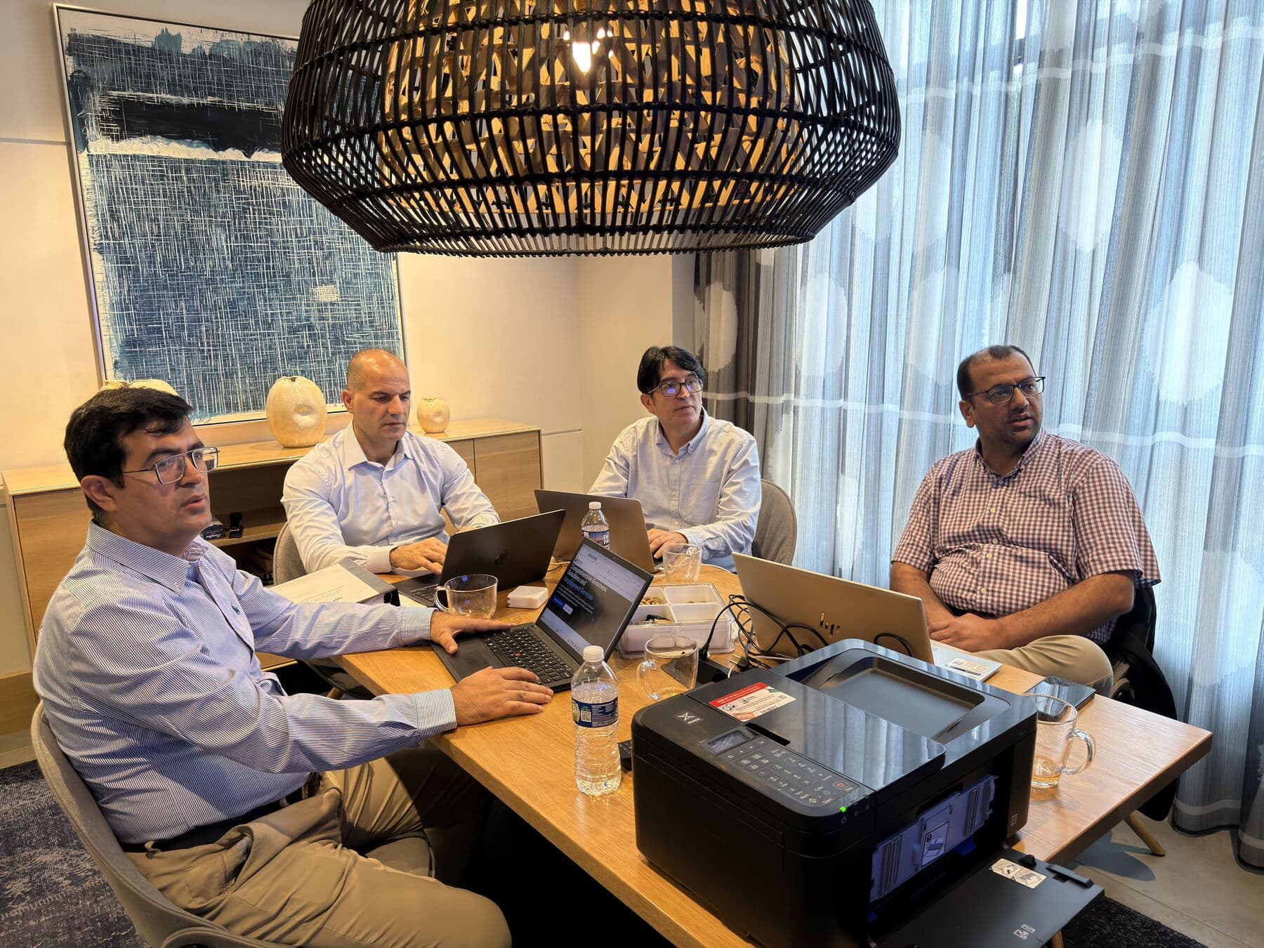 Four members of the Starforce team working together at a conference table